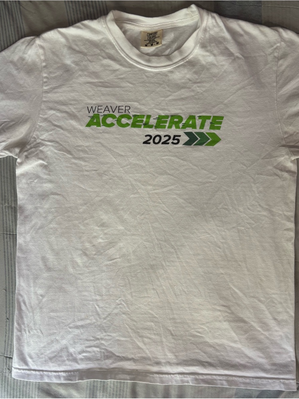 Weavers White Tee with Green 'Accelerate 2025' Graphic